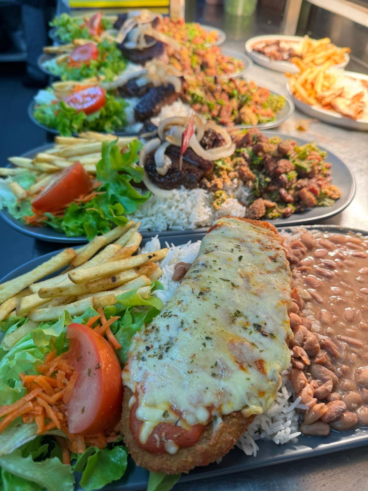 Chicken parmegiana with fries, rice and beans