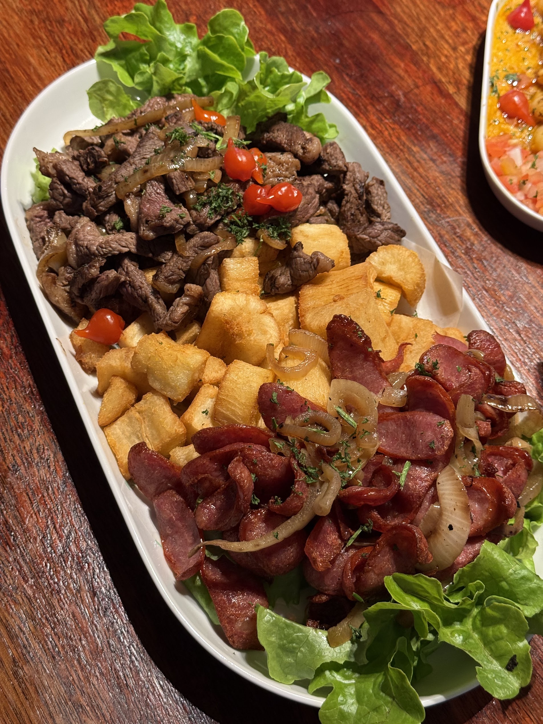 Bar snacks board with grilled meats, cassava fries and dips